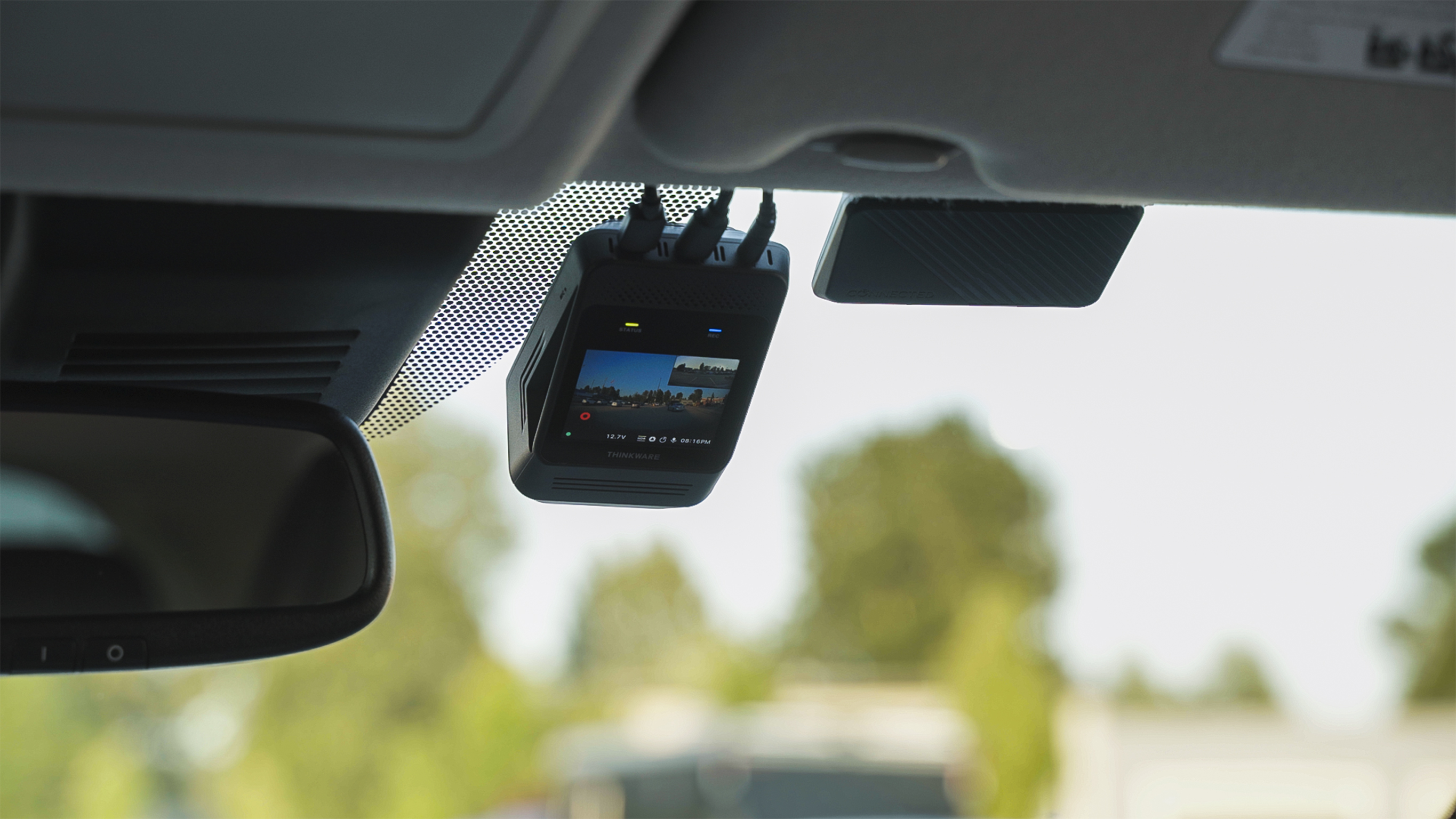 THINKWARE dash cam mounted on windshield recording front vehicle view