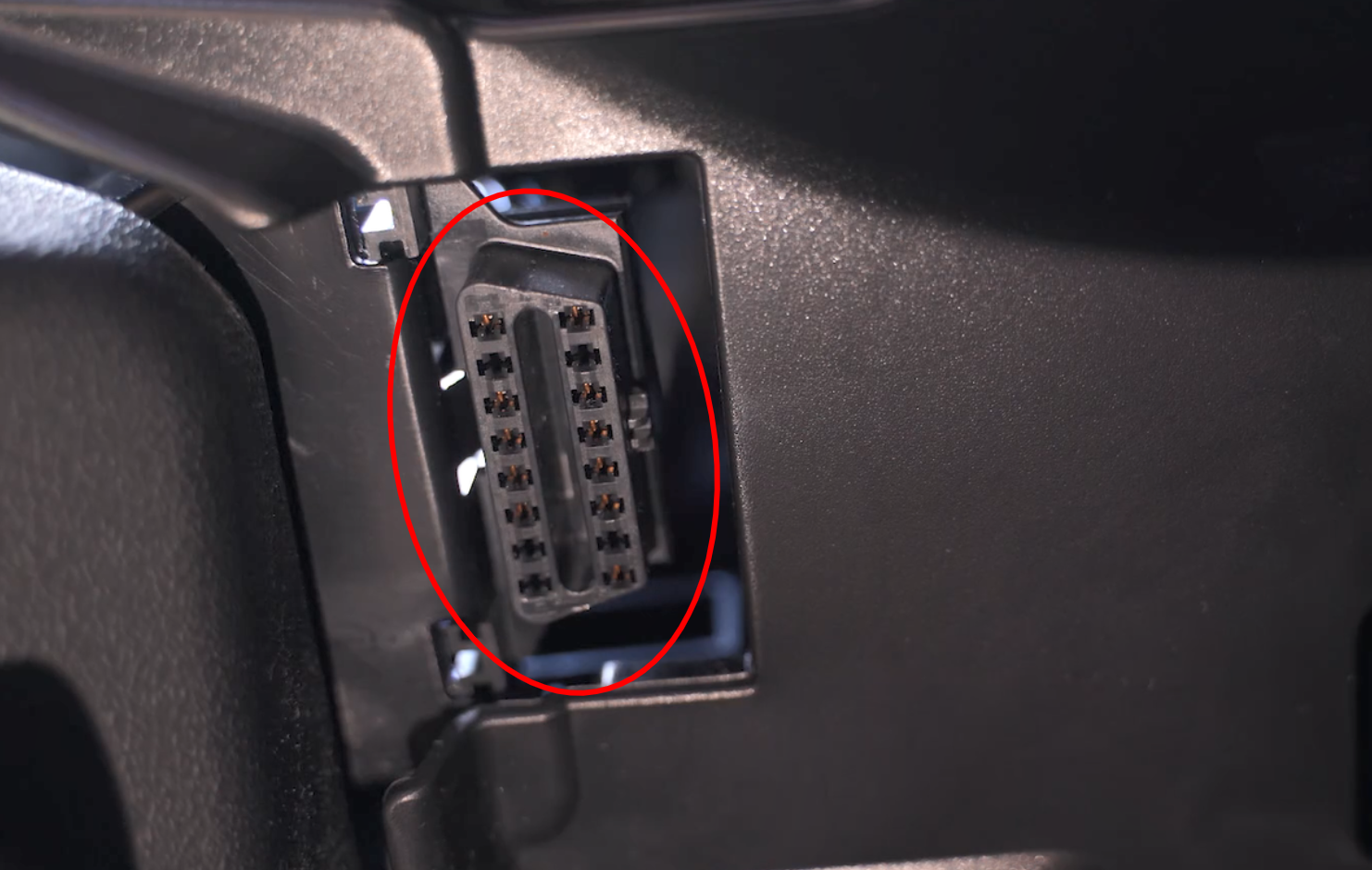 Location of the 16-pin OBD-II port under the dashboard