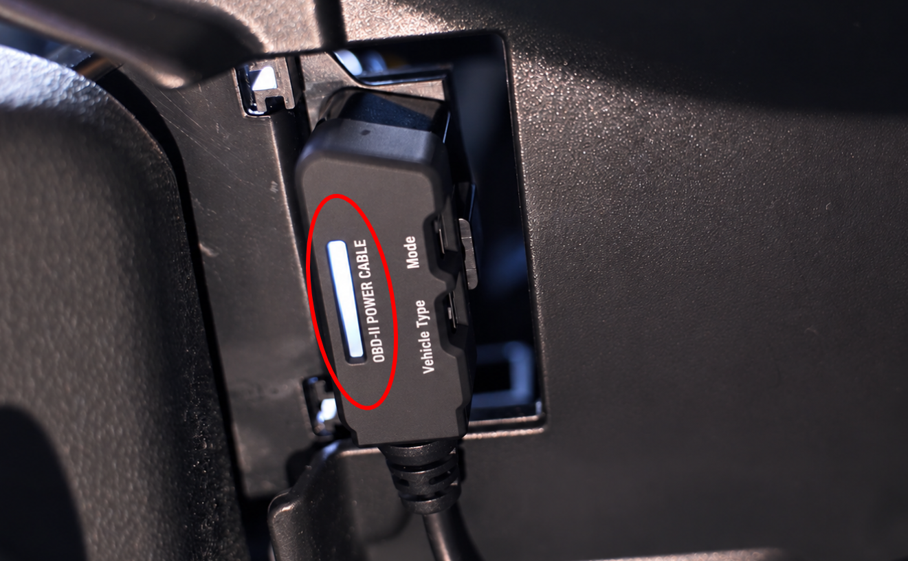 THINKWARE OBD-II Power Cable connector in a vehicle OBD-II port with its LED lit